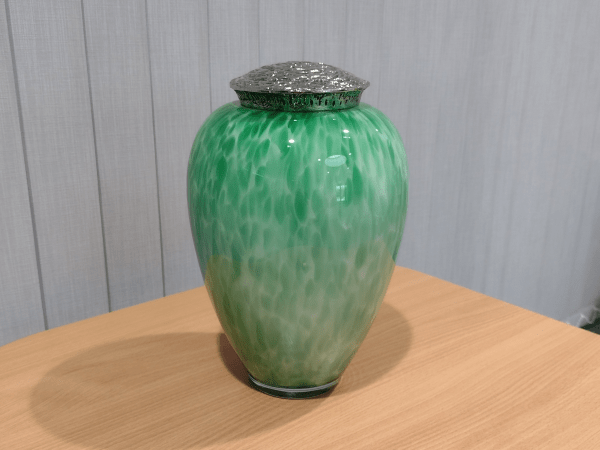Green flecked hand blown glass urn